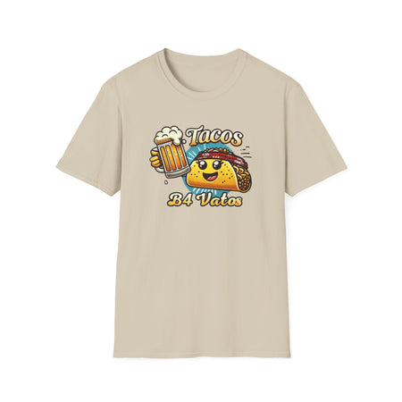 T-shirt featuring a fun 'Tacos B4 Vatos' design with a smiling taco character wearing a bandana and holding a beer mug. Perfect for taco lovers who prioritize food and fun with a playful style.