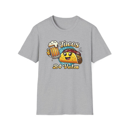 T-shirt featuring a fun 'Tacos B4 Vatos' design with a smiling taco character wearing a bandana and holding a beer mug. Perfect for taco lovers who prioritize food and fun with a playful style.