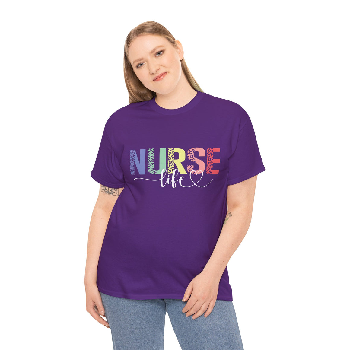 Smiling woman wearing a purple t-shirt with a colorful 'Nurse Life' design, showcasing nurse life t-shirt nurse week ideas for a stylish and professional look.
