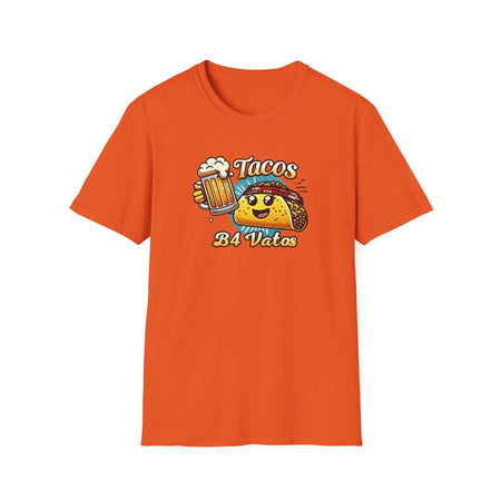 T-shirt featuring a fun 'Tacos B4 Vatos' design with a smiling taco character wearing a bandana and holding a beer mug. Perfect for taco lovers who prioritize food and fun with a playful style.