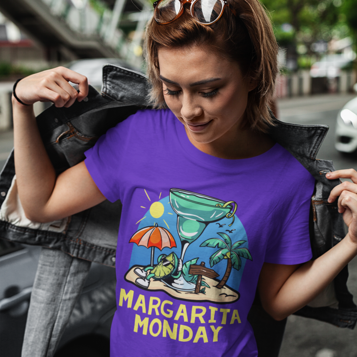 Margarita Monday T-shirt Design Ideas featuring a purple t-shirt with a fun tropical design of a margarita glass, sun umbrella, palm trees, and a sunny beach, paired with bold yellow text reading 'Margarita Monday.' Perfect for showcasing relaxed and festive vibes.
