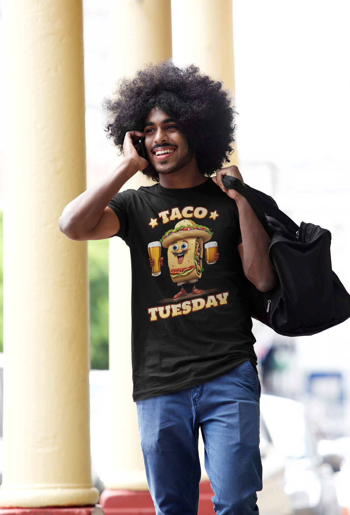 Black t-shirt with a fun 'Taco Tuesday' design featuring a smiling taco character holding two beers, ready to celebrate. Perfect for taco enthusiasts who enjoy Taco Tuesday with a playful twist.