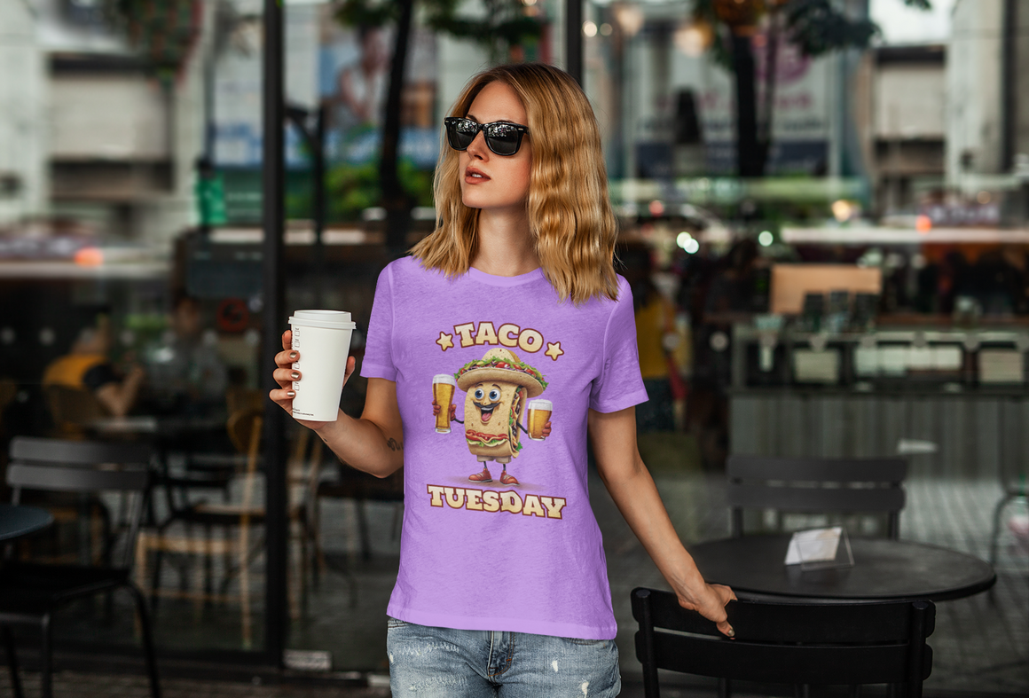 Light Purple T-shirt with a fun 'Taco Tuesday' design featuring a smiling taco character holding two beers, ready to celebrate. Perfect for taco enthusiasts who enjoy Taco Tuesday with a playful twist.