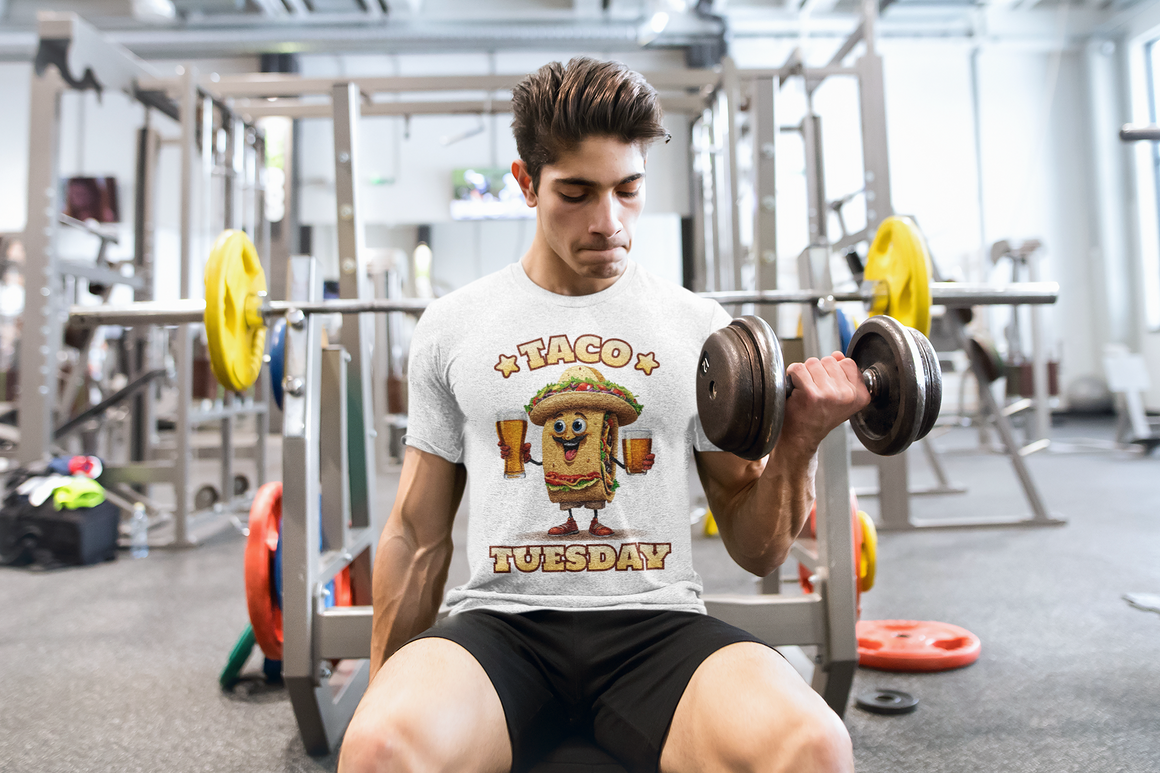 White t-shirt with a fun 'Taco Tuesday' design featuring a smiling taco character holding two beers, ready to celebrate. Perfect for taco enthusiasts who enjoy Taco Tuesday with a playful twist.