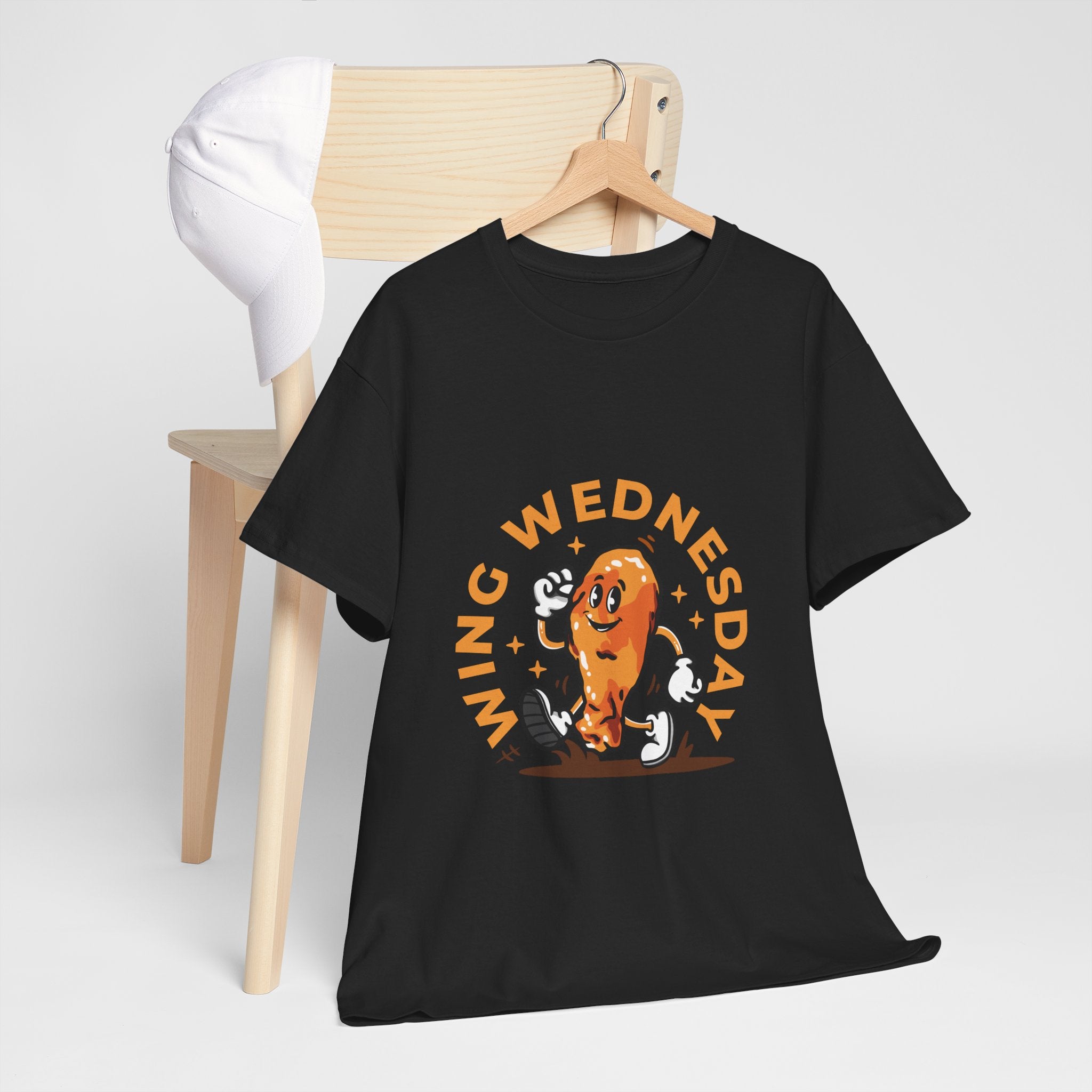 T-shirt featuring a fun 'Wing Wednesday' design with a cartoon-style chicken wing character in motion. Perfect for food lovers and those who enjoy celebrating Wing Wednesday in style.