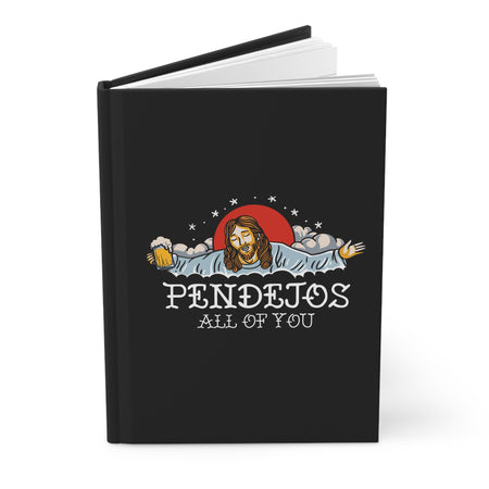 Illustration on a black journal cover featuring a humorous depiction of Jesus with outstretched arms, holding a mug of beer in one hand. The design includes a red sun in the background, clouds, and sta