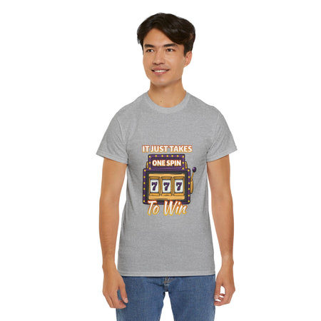 Person wearing a grey t-shirt with the text "It Just Takes One Spin To Win" and a slot machine showing triple sevens. This shirt is one of the humorous casino-inspired shirts, perfect for anyone who enjoys a touch of gambling humor and the excitement of casino games.