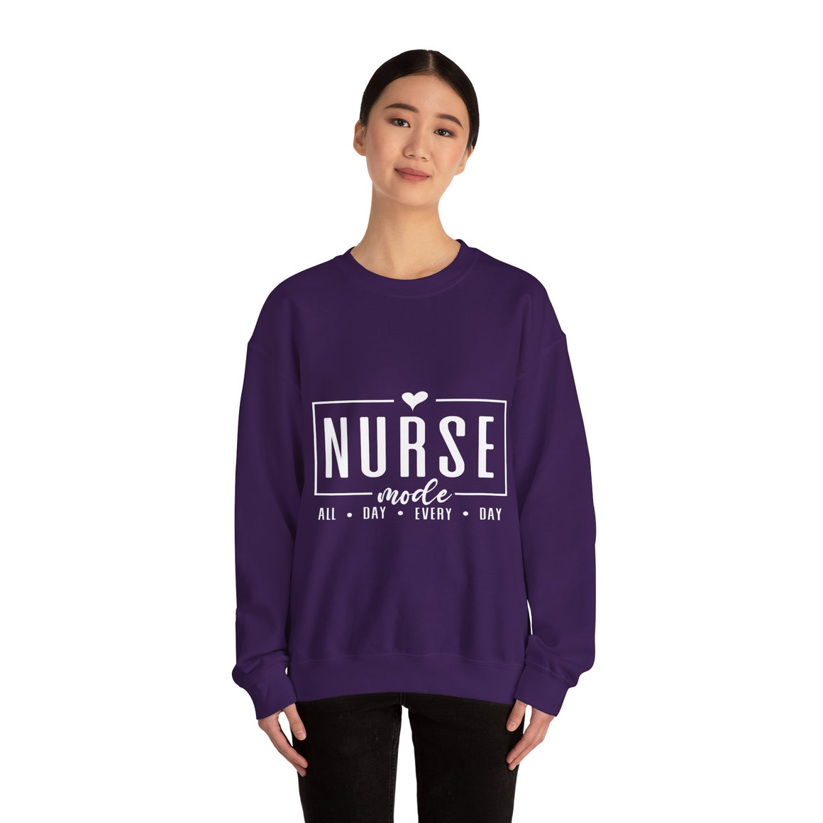 Woman wearing a purple sweatshirt with 'Nurse Mode All Day Every Day' printed in white text,  and hands on her waistband. Stylish design perfect for Nurses Week Custom Shirt Suggestions.