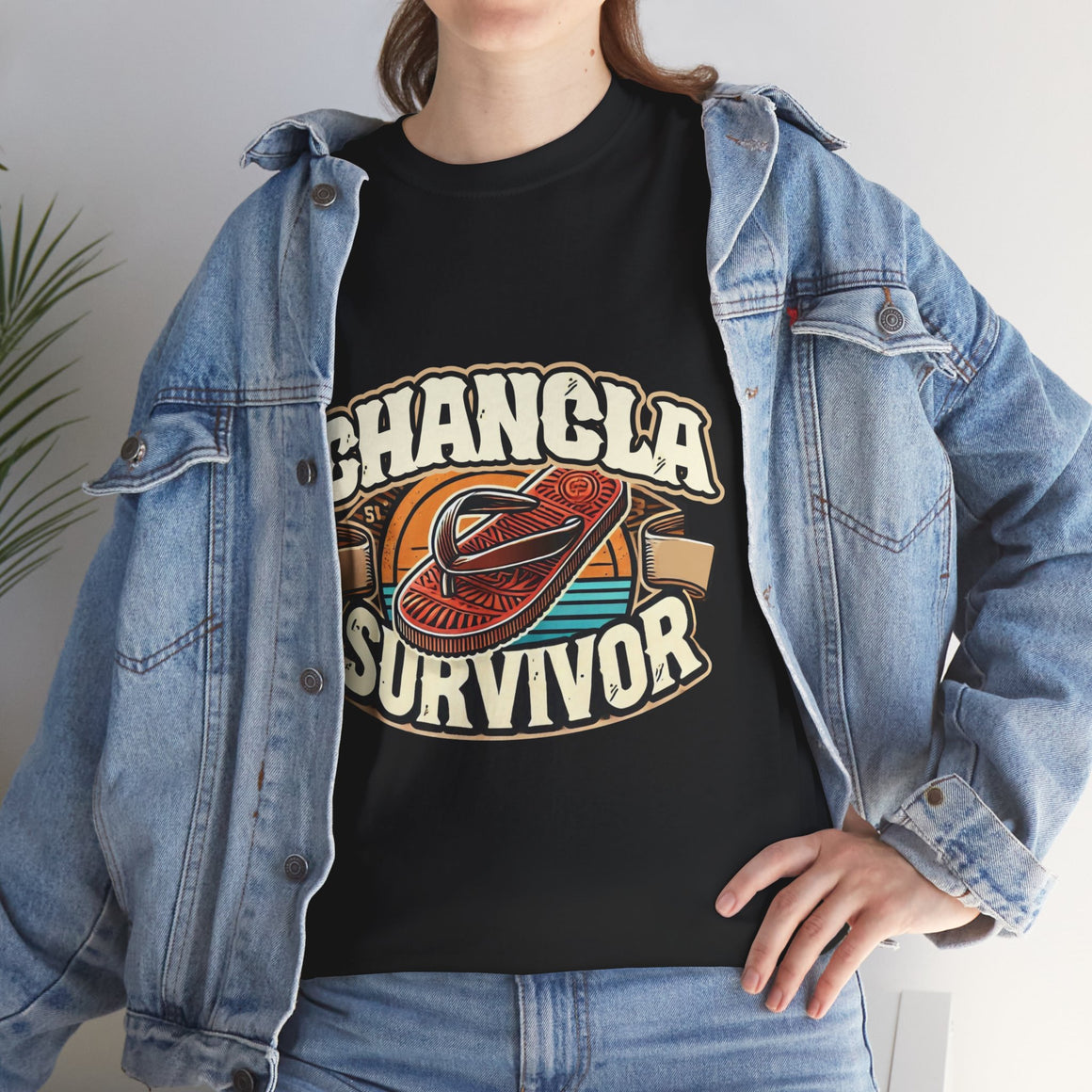 Funny Mexican t-shirt featuring the phrase 'Chancla Survivor. Black t-shirt featuring a retro-inspired 'Chancla Survivor' design with a graphic of a traditional sandal. Perfect for those with a sense of humor about family discipline and nostalgic cultural references.