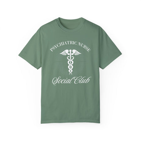 A nurse standing wearing a shirt that says Psychiatric Nurse Social Club and has a grapgic of a nurses caduceus