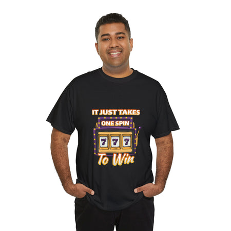 Person wearing a black t-shirt with the text "It Just Takes One Spin To Win" and a slot machine illustration showing triple sevens. This is one of the popular gambling style shirts funny and perfect for anyone who loves casino humor and the thrill of winning.