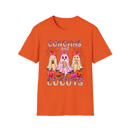 A orange t-shirt featuring the "Conchas and Cucuy's" design, part of our Latino-inspired Halloween apparel. The shirt displays three cute ghost figures holding conchas and decorated with pink bows, spider webs, and festive pumpkin accents, combining Halloween spirit with Día de los Muertos charm. This unisex, soft-style shirt offers a unique blend of spooky and sweet for the Halloween season.