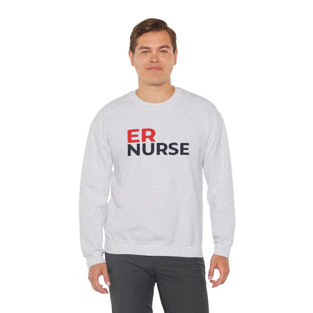 A man wearing a light gray ER Nurse Sweatshirt, standing confidently against a white background.