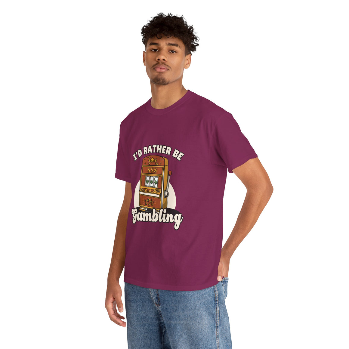 Person wearing a maroon t-shirt with the text "I'd Rather Be Gambling" and an illustration of a slot machine. This funny casino game shirt is perfect for anyone who loves gambling humor and casino-inspired designs