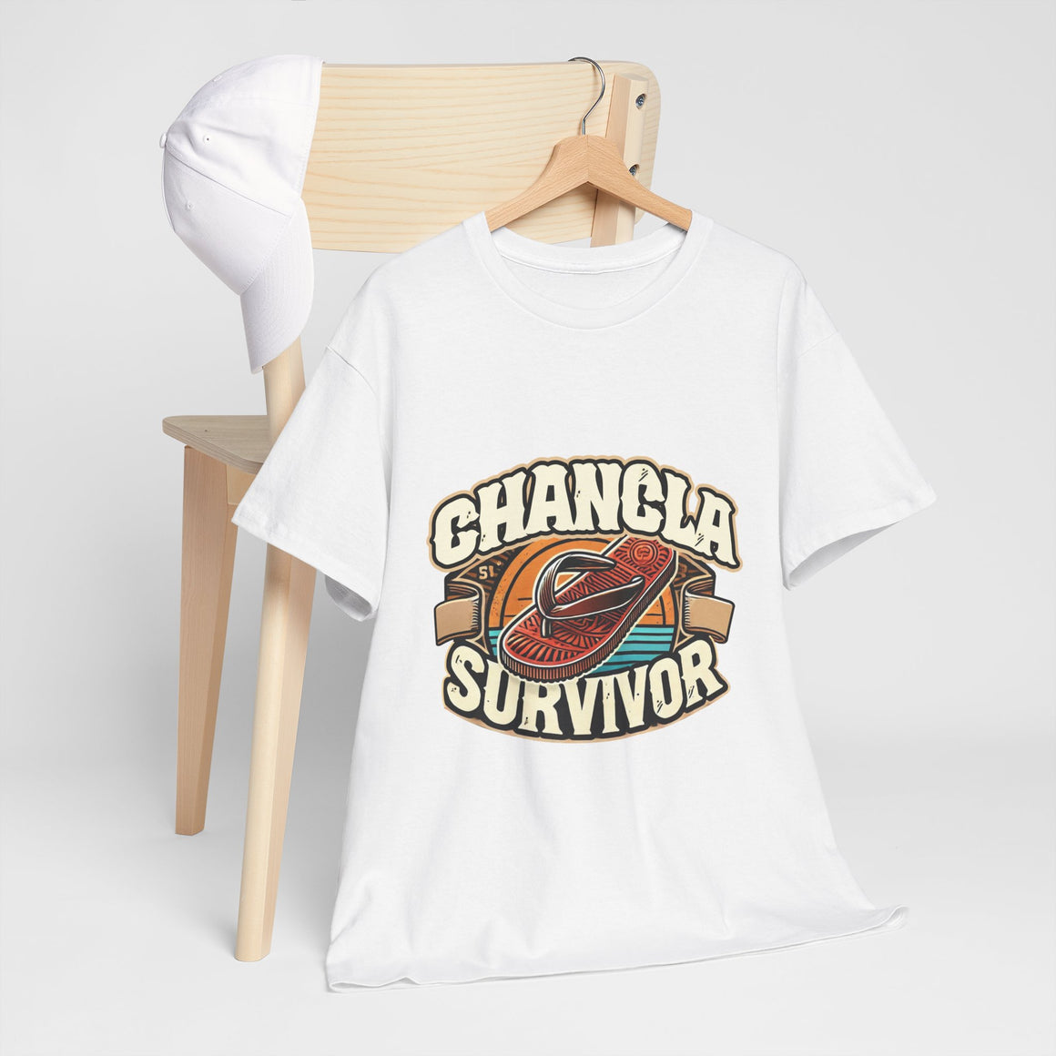 Funny Mexican t-shirt featuring the phrase 'Chancla Survivor. White T-shirt featuring a retro-inspired 'Chancla Survivor' design with a graphic of a traditional sandal. Perfect for those with a sense of humor about family discipline and nostalgic cultural references.