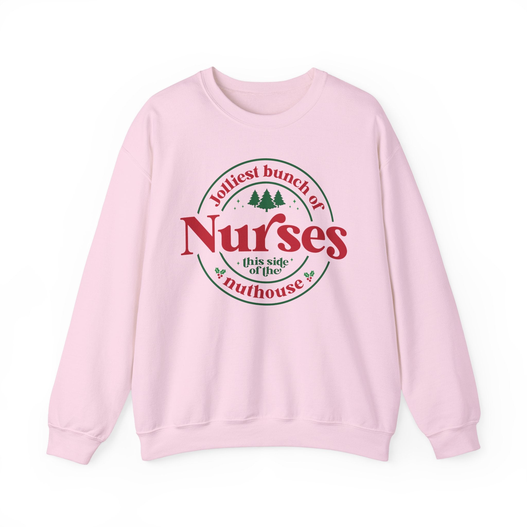 Pink Christmas sweatshirt with the humorous phrase 'Jolliest bunch of Nurses this side of the nuthouse,' surrounded by festive elements like trees and holly. A perfect holiday-themed gift for nurses with a sense of humor, celebrating Christmas in a fun and lighthearted style.