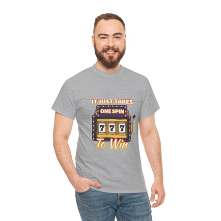 Person wearing a grey t-shirt with the text "It Just Takes One Spin To Win" and a slot machine showing triple sevens. This shirt is one of the humorous casino-inspired shirts, perfect for anyone who enjoys a touch of gambling humor and the excitement of casino games.