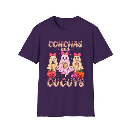 Woman wearing a purple t-shirt featuring the "Conchas and Cucuy's" design, part of our Latino-inspired Halloween apparel. The shirt displays three cute ghost figures holding conchas and decorated with pink bows, spider webs, and festive pumpkin accents, combining Halloween spirit with Día de los Muertos charm. This unisex, soft-style shirt offers a unique blend of spooky and sweet for the Halloween season.