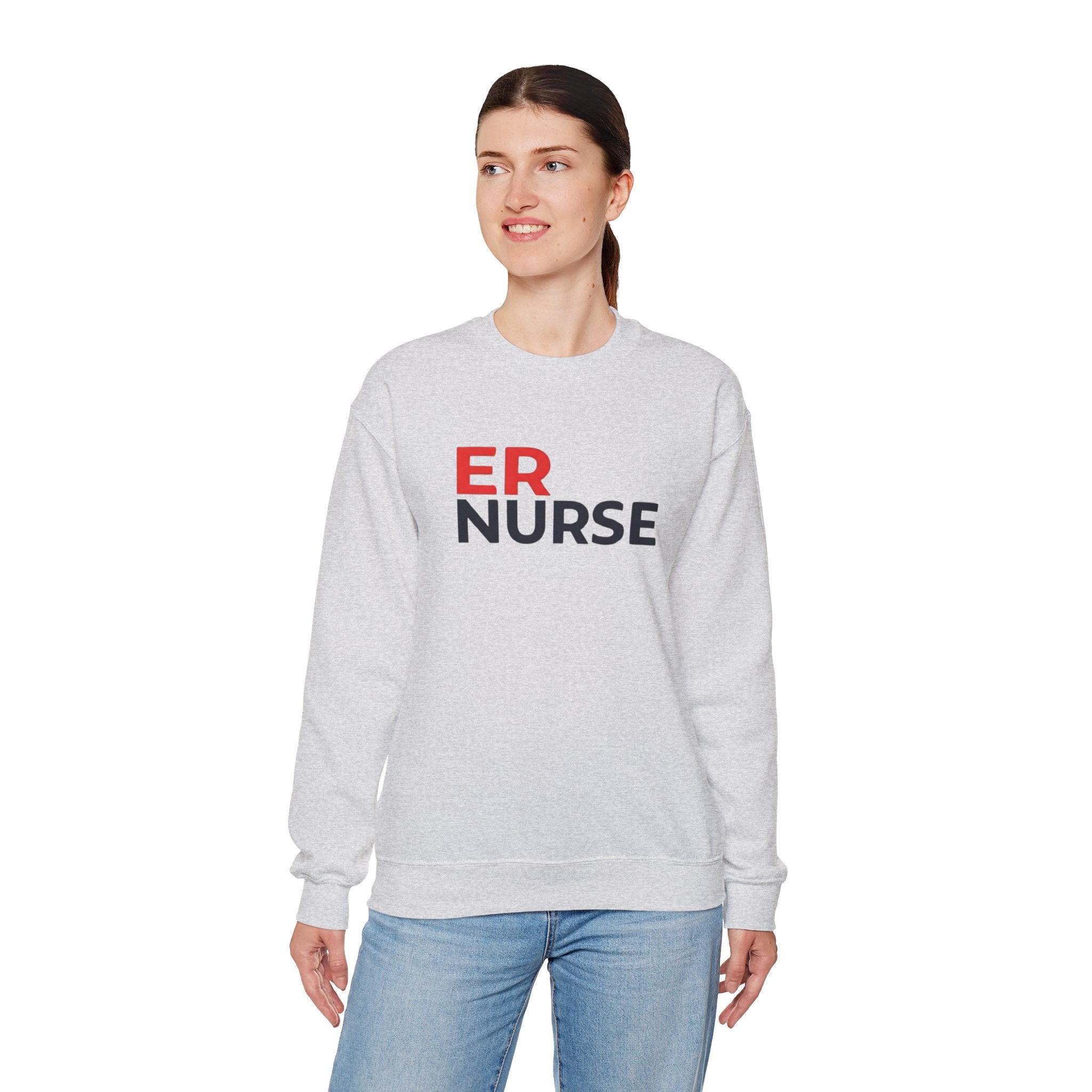 A woman wearing a light gray ER Nurse Sweatshirt, looking to the side, standing against a white background.