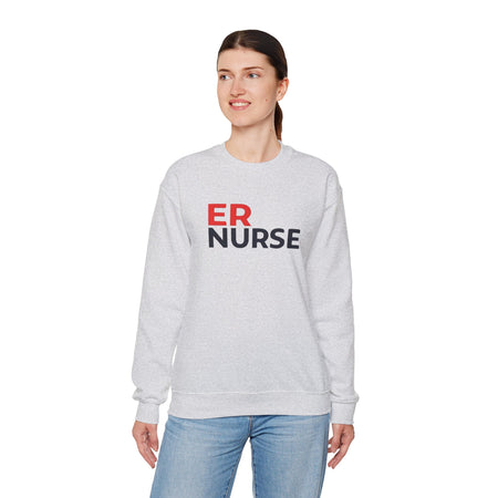A woman wearing a light gray ER Nurse Sweatshirt, looking to the side, standing against a white background.