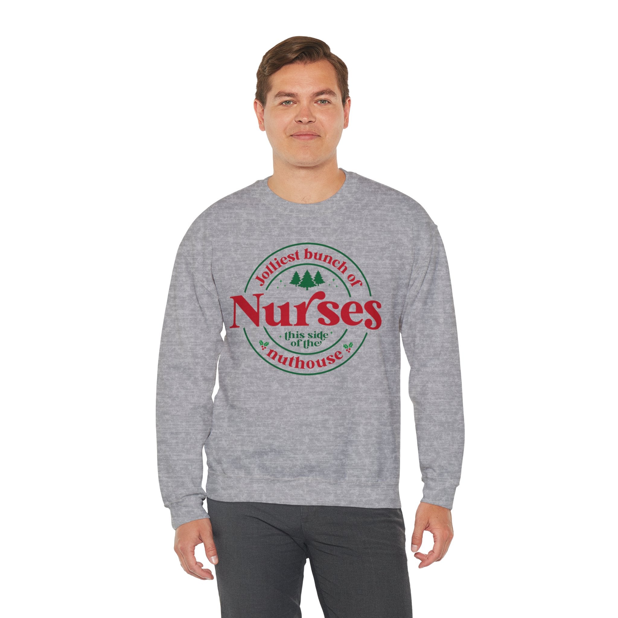 Grey Christmas sweatshirt with the humorous phrase 'Jolliest bunch of Nurses this side of the nuthouse,' surrounded by festive elements like trees and holly. A perfect holiday-themed gift for nurses with a sense of humor, celebrating Christmas in a fun and lighthearted style.