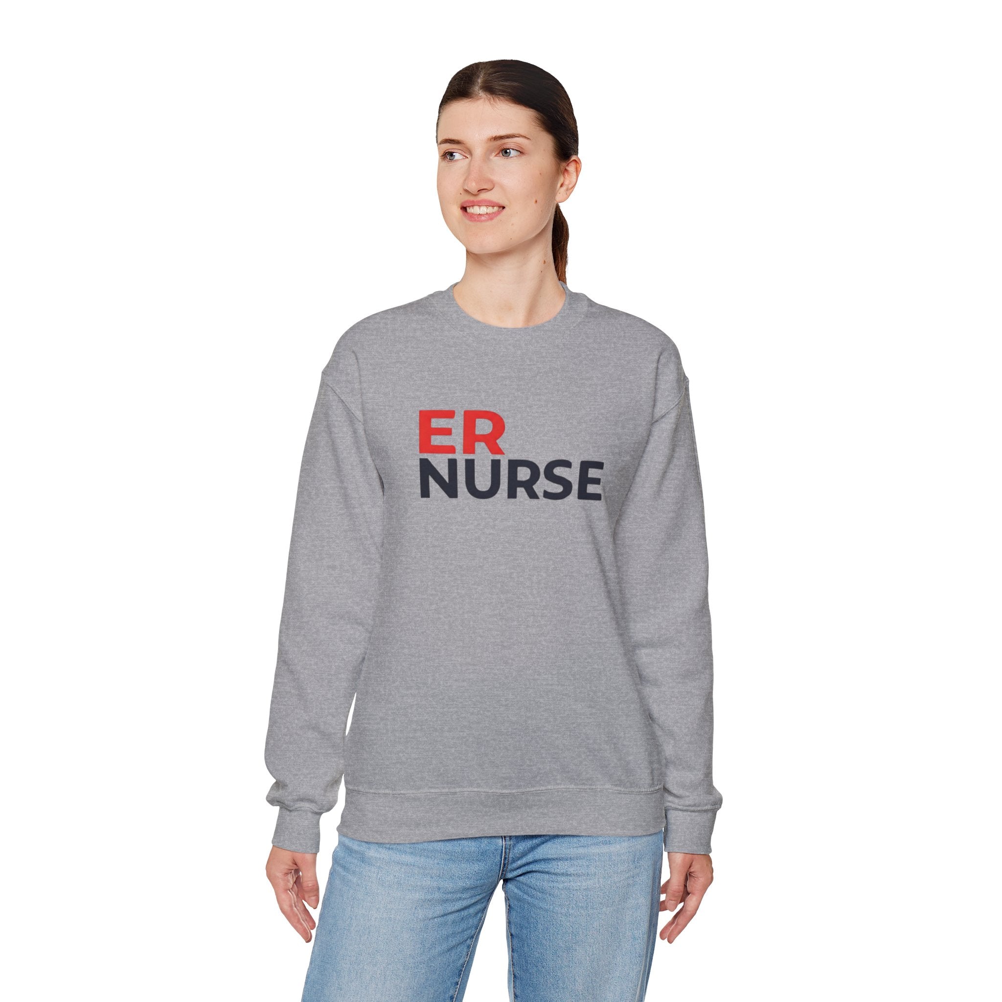 A woman wearing a dark gray ER Nurse Sweatshirt, looking to the side, standing against a white background.