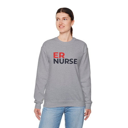 A woman wearing a dark gray ER Nurse Sweatshirt, looking to the side, standing against a white background.