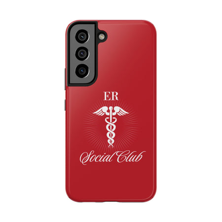 ER Social Club tough phone case in vibrant red with a white Caduceus symbol, representing emergency medical services. The case features the text 'ER Social Club' in elegant script, combining style with durable protection for healthcare professionals. Compatible with iPhone and Samsung models, this case offers impact resistance and a glossy finish for a professional and stylish look.