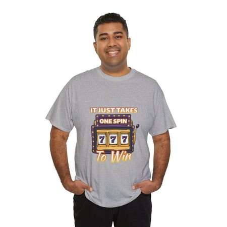 Person wearing a grey t-shirt with the text "It Just Takes One Spin To Win" and a slot machine showing triple sevens. This shirt is one of the humorous casino-inspired shirts, perfect for anyone who enjoys a touch of gambling humor and the excitement of casino games.