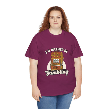 Person wearing a maroon t-shirt with the text "I'd Rather Be Gambling" and an illustration of a slot machine. This funny casino game shirt is perfect for anyone who loves gambling humor and casino-inspired designs