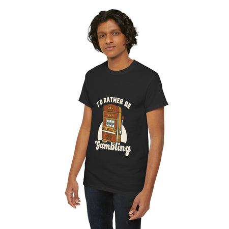 Person wearing a black t-shirt with the text "I'd Rather Be Gambling" and an illustration of a slot machine. This funny casino game shirt is perfect for anyone who loves gambling humor and casino-inspired designs