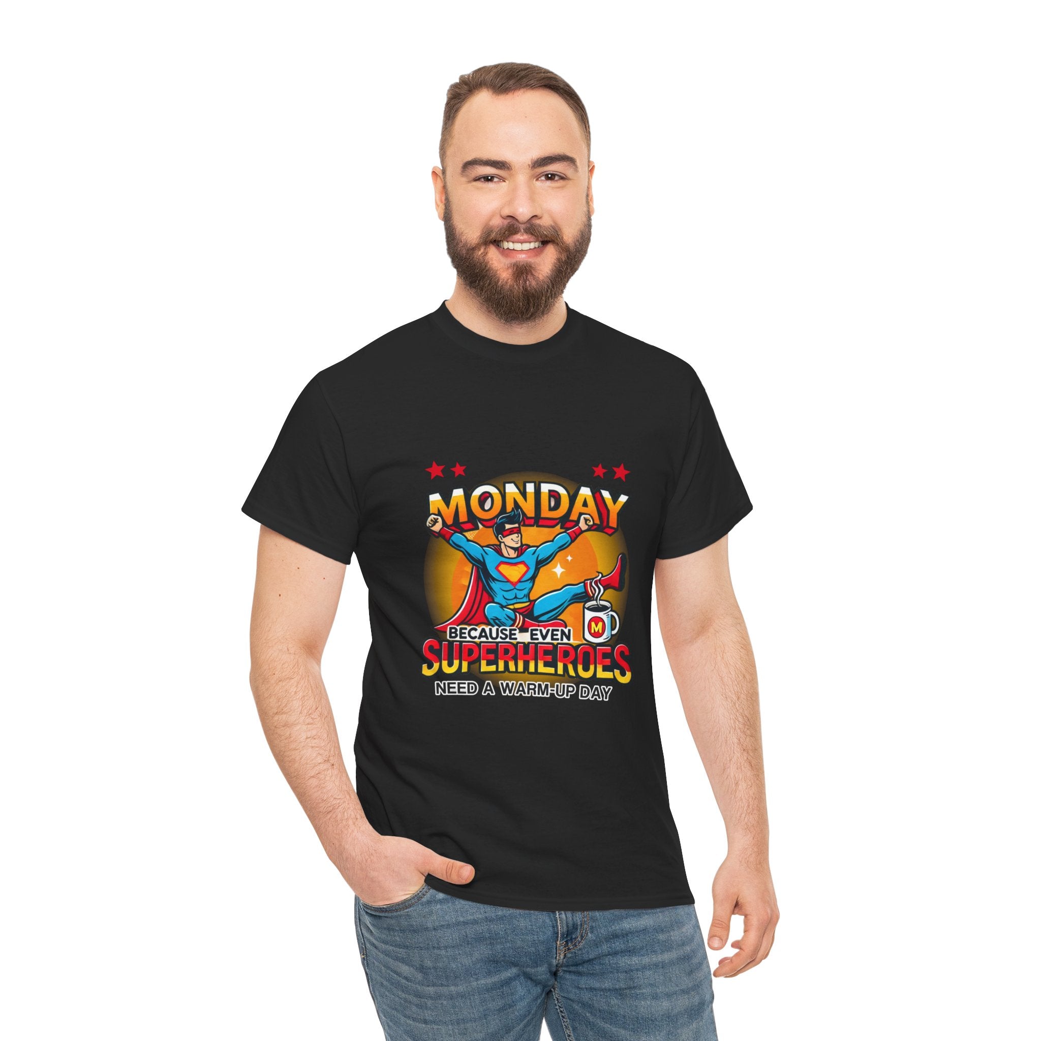 a Man wearing a black t-shirt with a humorous design featuring a superhero and the text 'Monday - Because Even Superheroes Need a Warm-Up Day.' A playful option in funny t-shirts for adults.