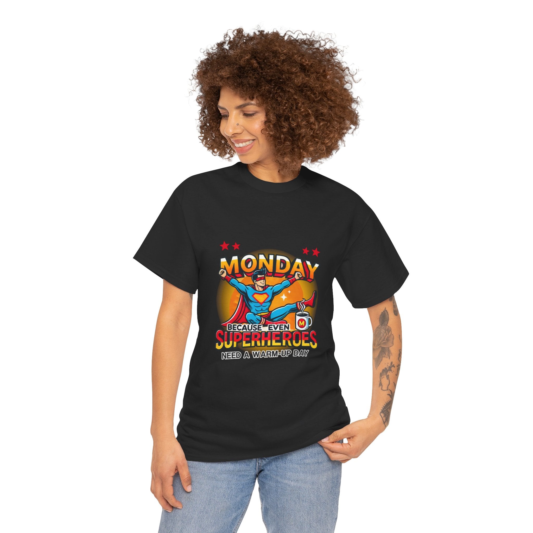 a woman wearing a black t-shirt with a humorous design featuring a superhero and the text 'Monday - Because Even Superheroes Need a Warm-Up Day.' A playful option in funny t-shirts for adults.