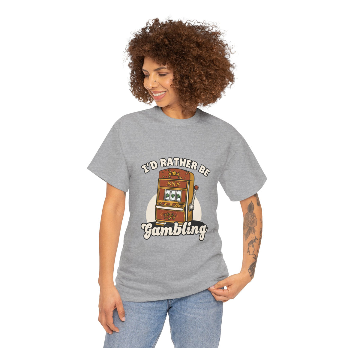 Person wearing a grey t-shirt with the text "I'd Rather Be Gambling" and an illustration of a slot machine. This funny casino game shirt is perfect for anyone who loves gambling humor and casino-inspired designs