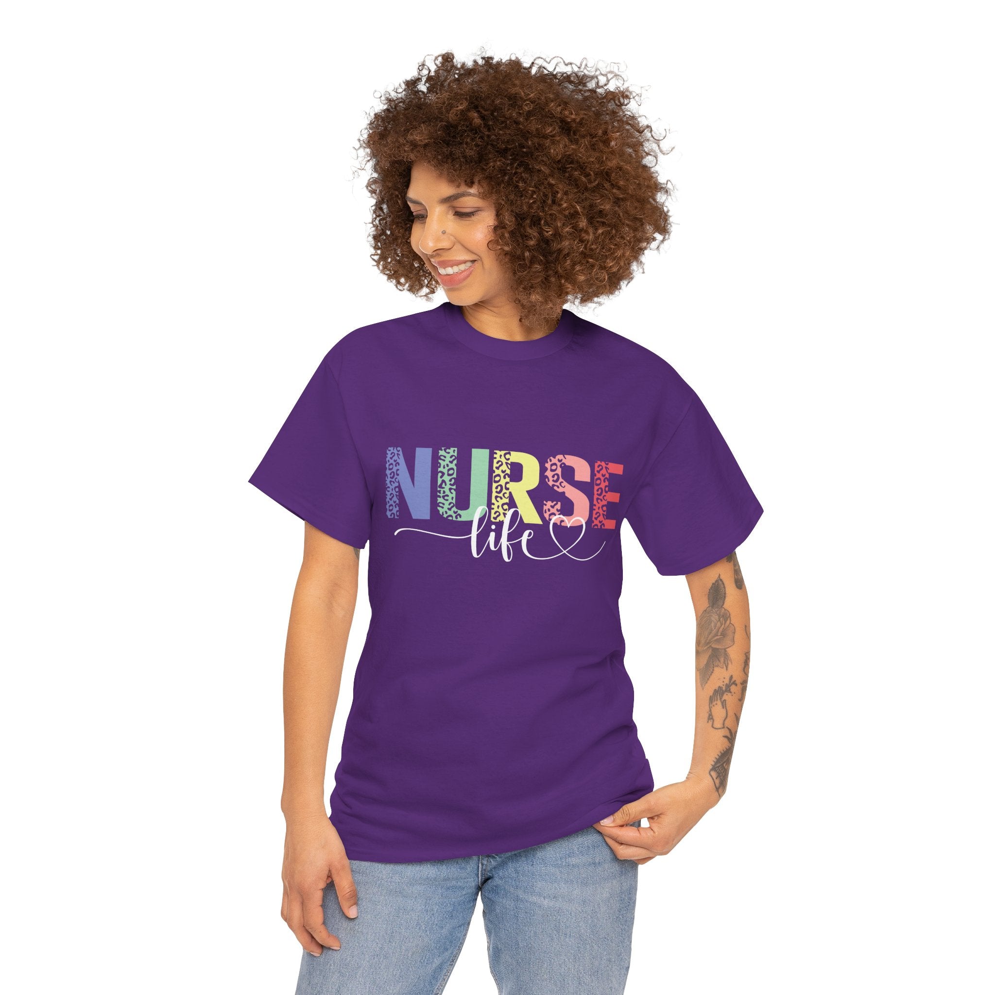 Smiling woman wearing a purple t-shirt with a colorful 'Nurse Life' design, showcasing nurse life t-shirt nurse week ideas for a stylish and professional look.