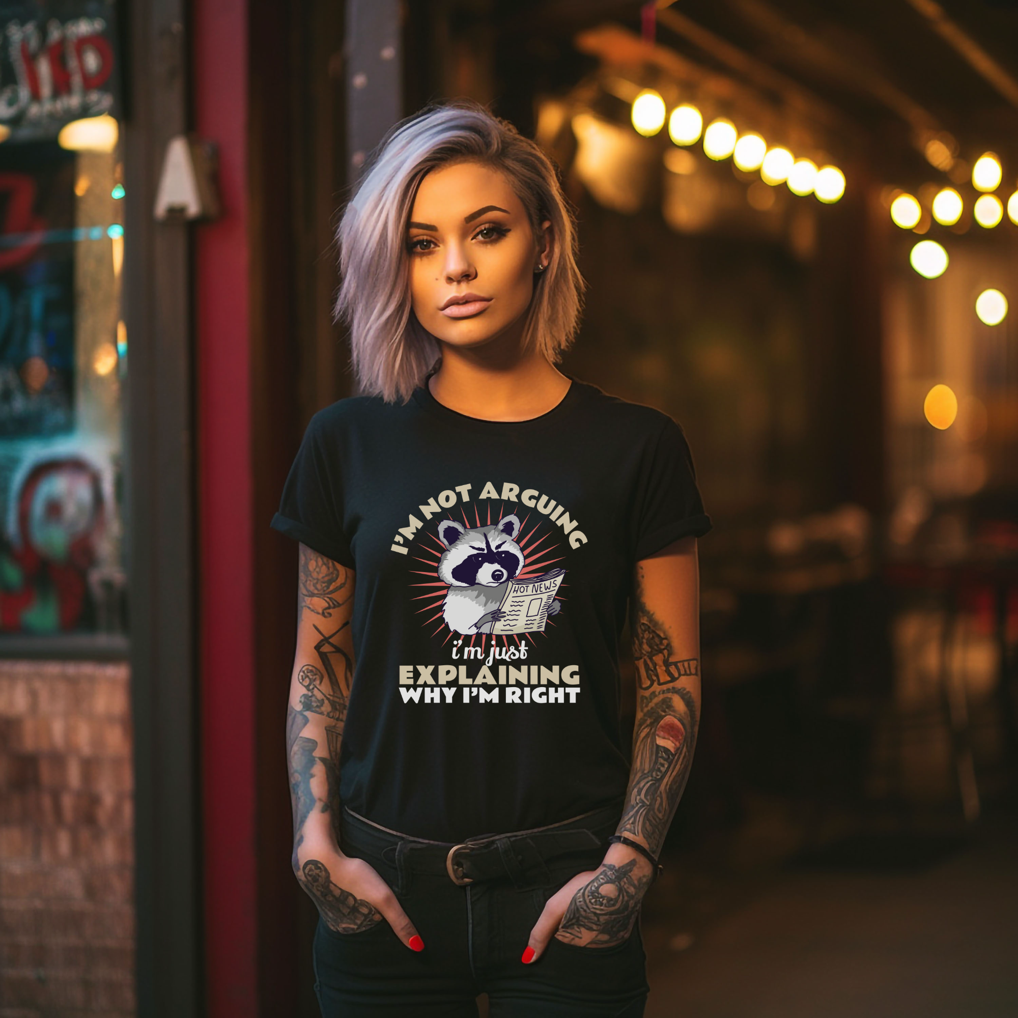 Black T-shirt featuring a humorous raccoon graphic holding a newspaper with the text 'I'm Not Arguing, I'm Just Explaining Why I'm Right.' Ideal for those with a witty, playful personality who appreciate sarcastic humor.