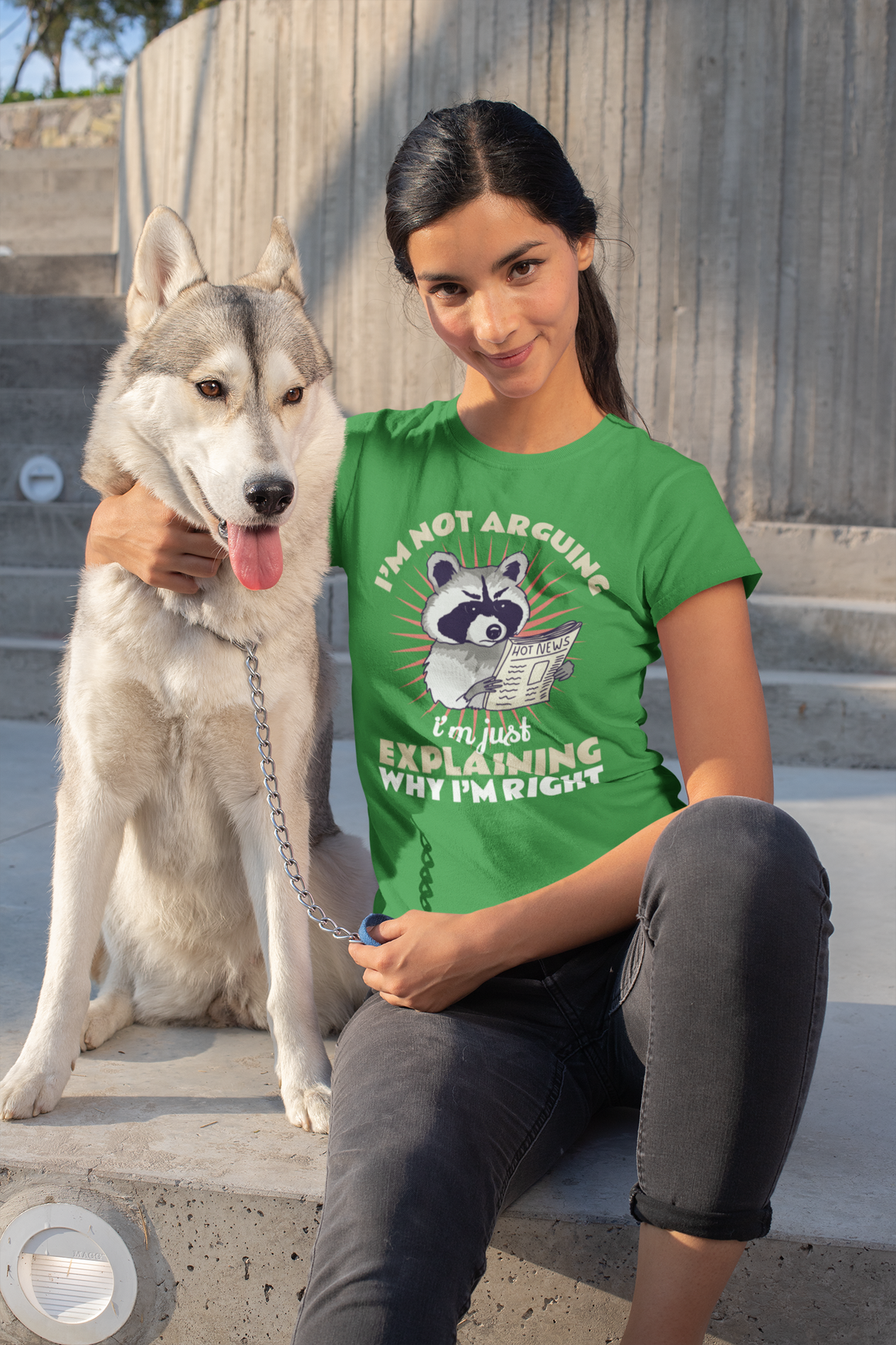 T-shirt featuring a humorous raccoon graphic holding a newspaper with the text 'I'm Not Arguing, I'm Just Explaining Why I'm Right.' Ideal for those with a witty, playful personality who appreciate sarcastic humor.