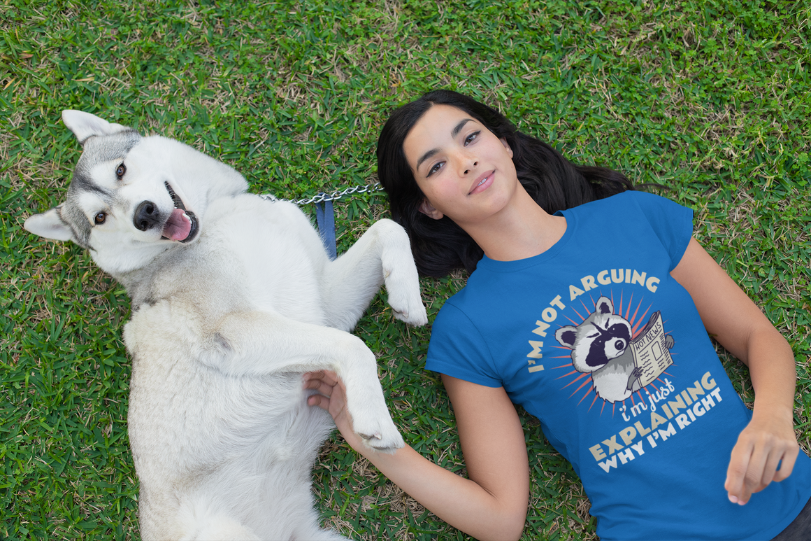 T-shirt featuring a humorous raccoon graphic holding a newspaper with the text 'I'm Not Arguing, I'm Just Explaining Why I'm Right.' Ideal for those with a witty, playful personality who appreciate sarcastic humor.