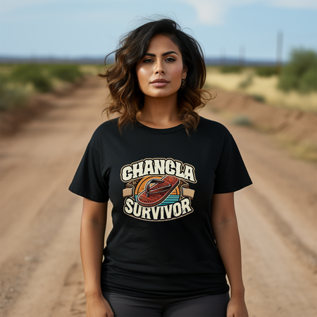 Funny Mexican t-shirt featuring the phrase 'Chancla Survivor.' A woman standing confidently on a dirt road, wearing a black shirt that humorously celebrates the 'chancla' tradition. Perfect for those with a sense of humor about Mexican culture and family discipline.
