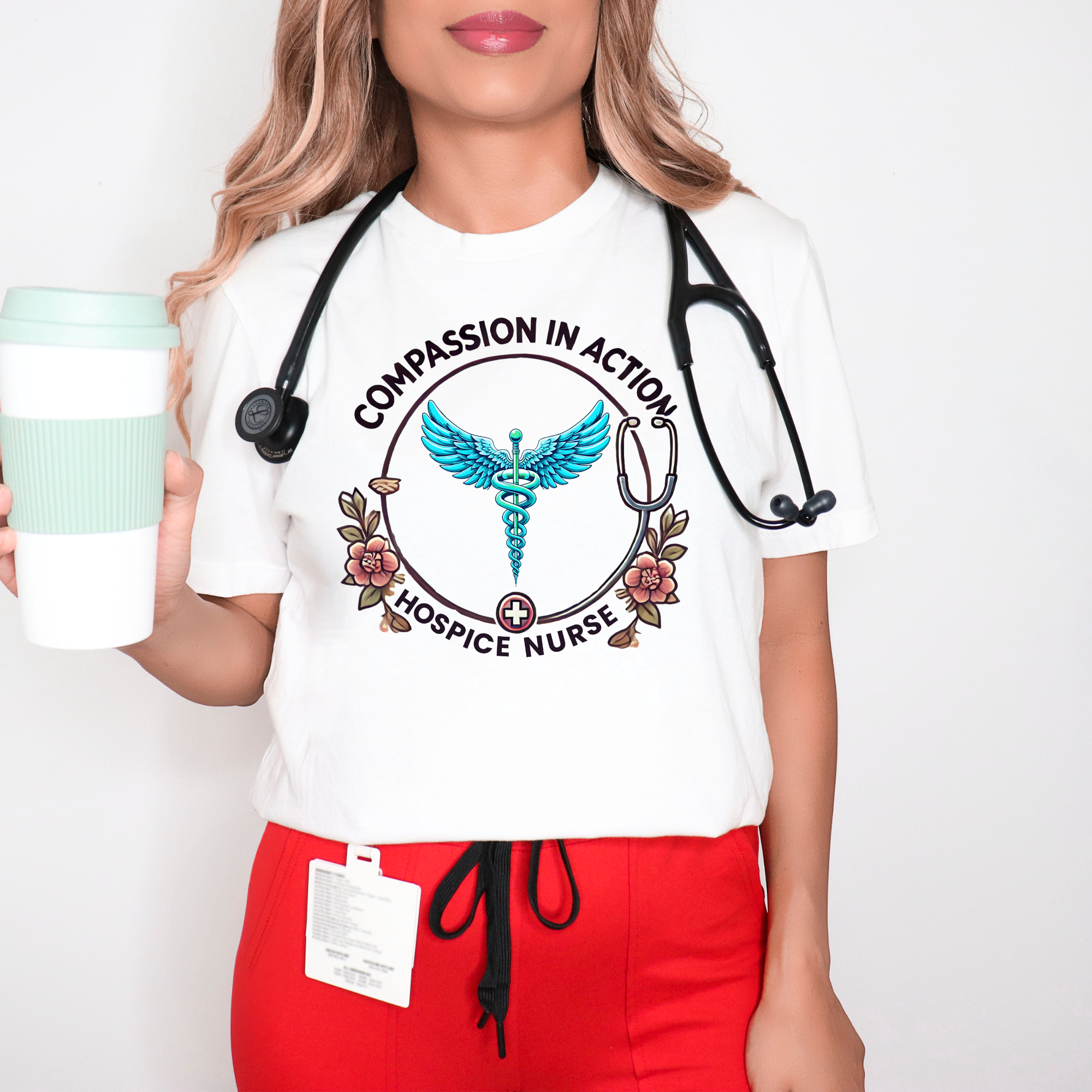 White hospice nurse t-shirt featuring the phrase 'Compassion in Action' with a medical caduceus symbol, flowers, and stethoscope graphic. Ideal for hospice nurses who bring compassion and care to their work.