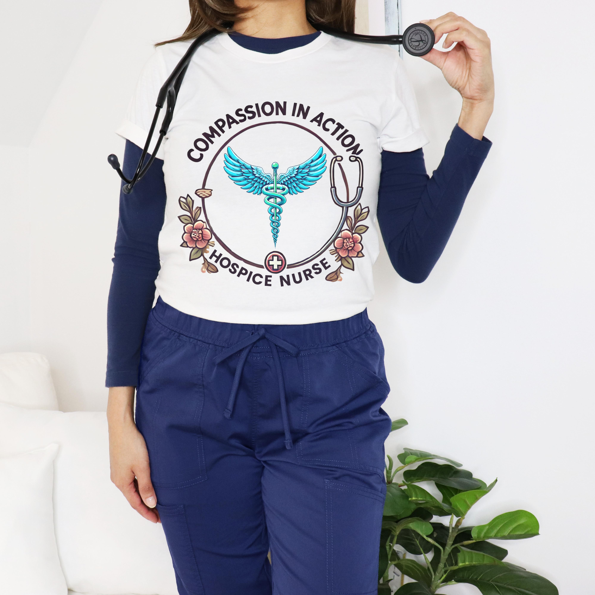 White hospice nurse t-shirt featuring the phrase 'Compassion in Action' with a medical caduceus symbol, flowers, and stethoscope graphic. Ideal for hospice nurses who bring compassion and care to their work.