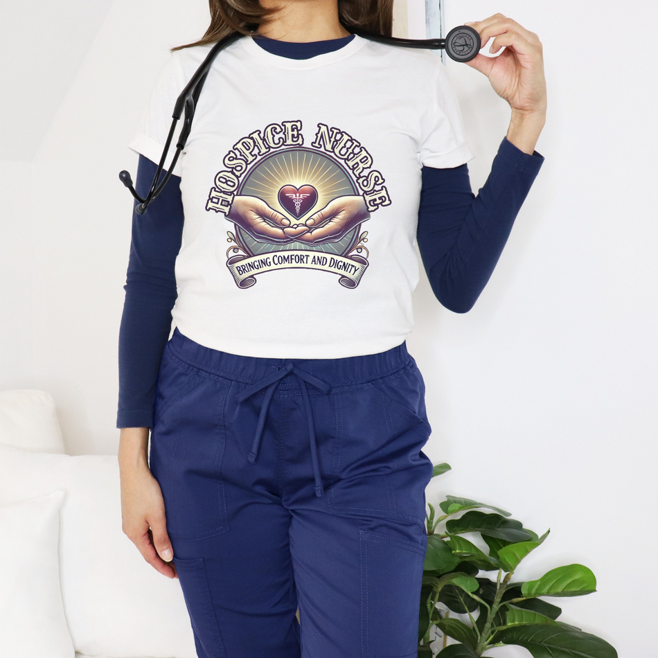 White hospice nurse t-shirt featuring a compassionate design with hands holding a heart and the phrase 'Bringing Comfort and Dignity,' symbolizing the care and support provided by hospice nurses. Ideal for hospice nurses who are dedicated to their mission.