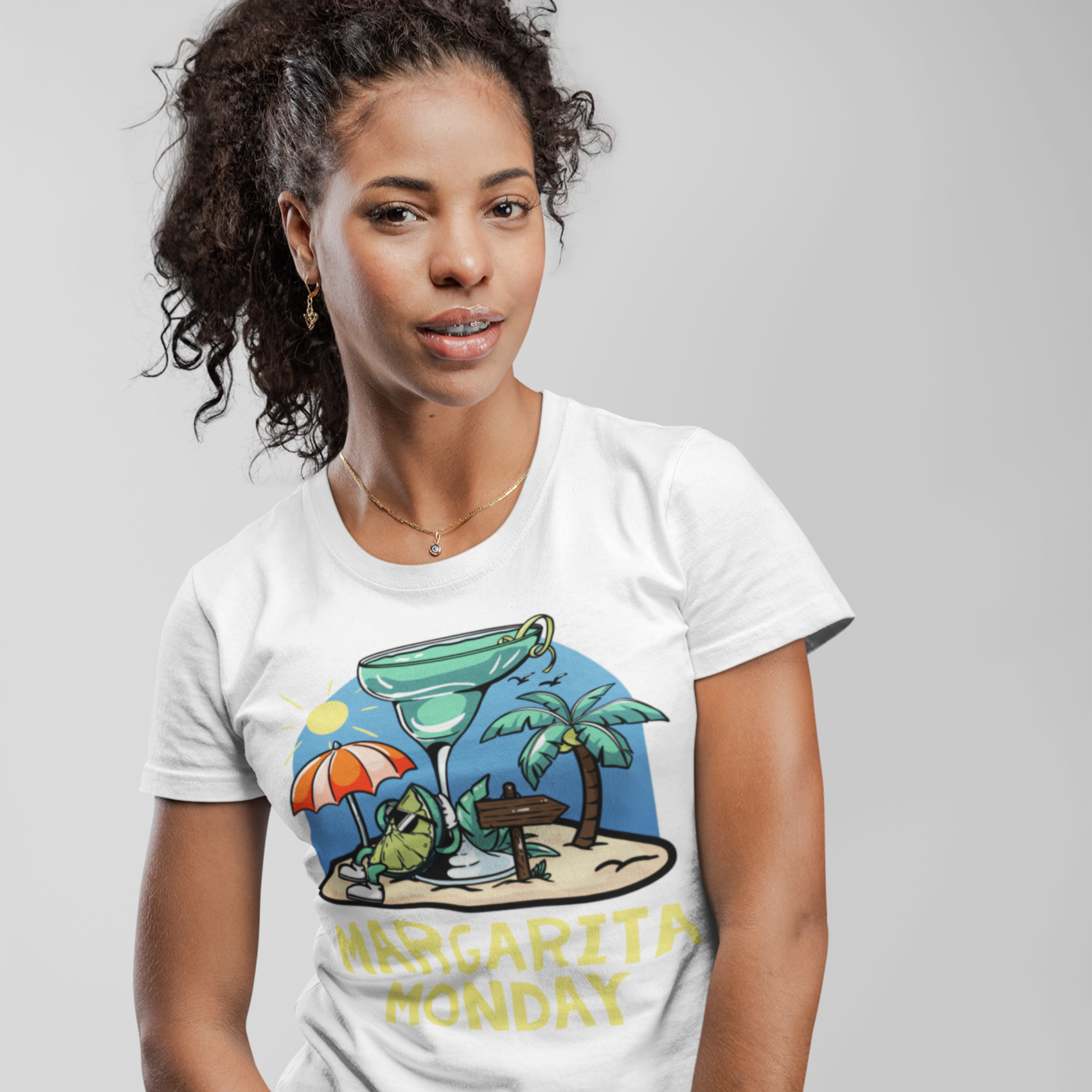 woman wearing a white t-shirt with a fun "Margarita Monday" design, showcasing tropical vibes with a large margarita glass, palm trees, and a beach scene. This image highlights creative Margarita Monday t-shirt design ideas, perfect for adding a touch of relaxation and celebration to casual outfits. The colorful artwork captures the spirit of a beach getaway, making this shirt a great choice for Margarita Monday fans.