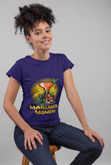 Woman wearing a purple T-shirt with a "Margarita Monday" design, featuring a vibrant margarita glass illustration and bold yellow text. This is one of the trendy Margarita Monday T-shirt styles, adding a fun and playful vibe to her casual look, perfect for celebrating Margarita Monday in style.