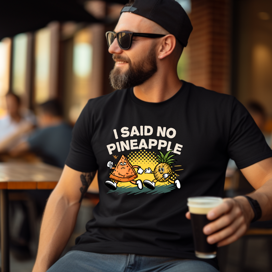 Black T-shirt featuring a humorous 'I Said No Pineapple' design with animated characters of a pizza slice and a pineapple in a playful scene. Perfect for pizza lovers with a sense of humor about the pineapple-on-pizza debate.