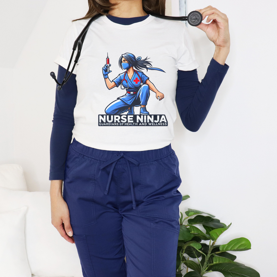 A nurse standing with a stethoscope around her neck wearing a t shirt with a graphic of a Nurse Ninja on the front of it.