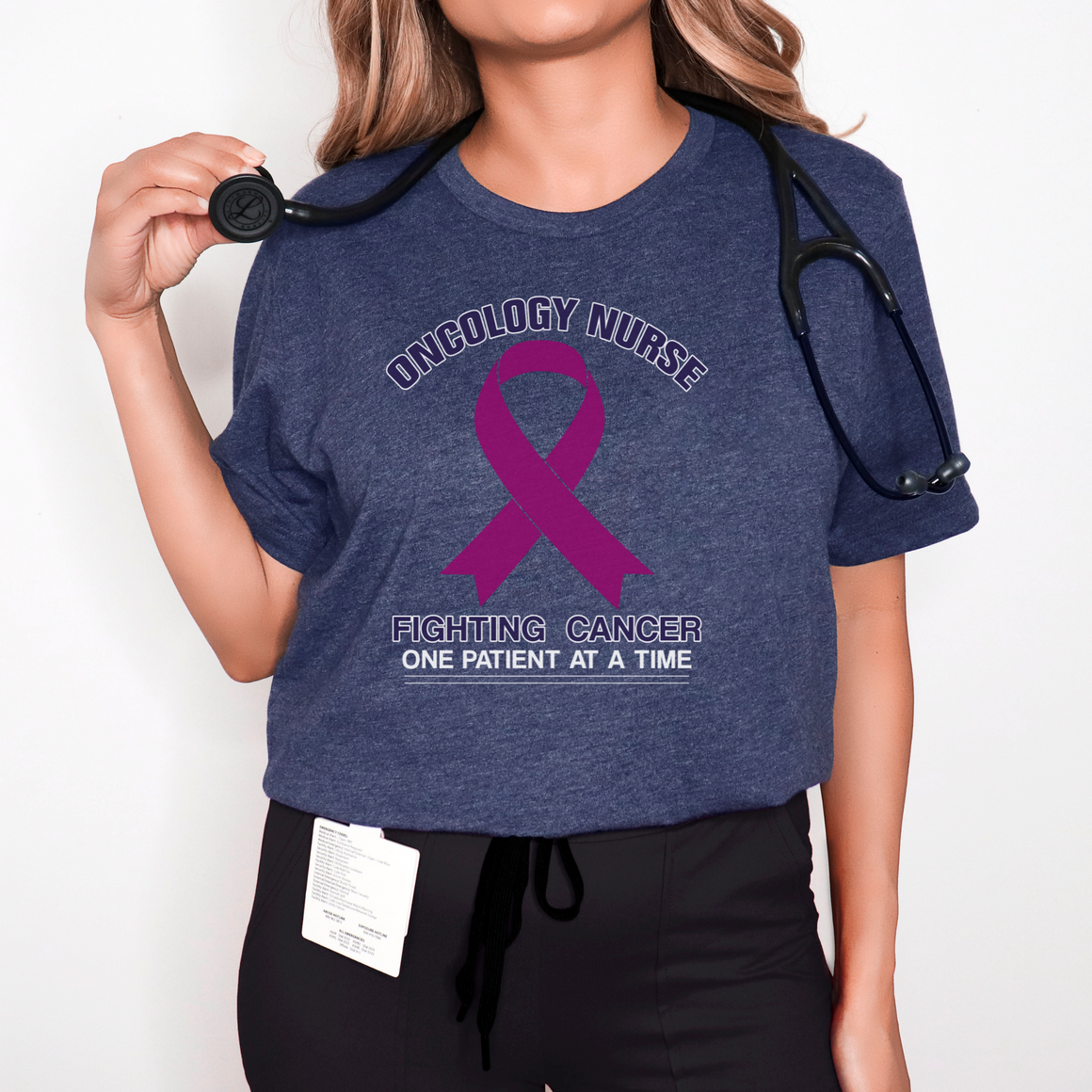 Close-up of a navy blue t-shirt with the words 'Oncology Nurse' and 'Fighting Cancer One Patient at a Time' alongside a purple cancer ribbon. This design is part of the oncology nurse t-shirt designs collection, symbolizing strength and dedication to patient care.