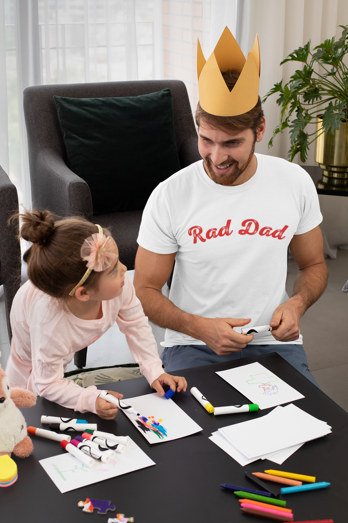 A Man standing ooutside wearing a t shirt with a Red Rad Dad Graphic on the front