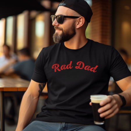 A Man standing ooutside wearing a t shirt with a Red Rad Dad Graphic on the front