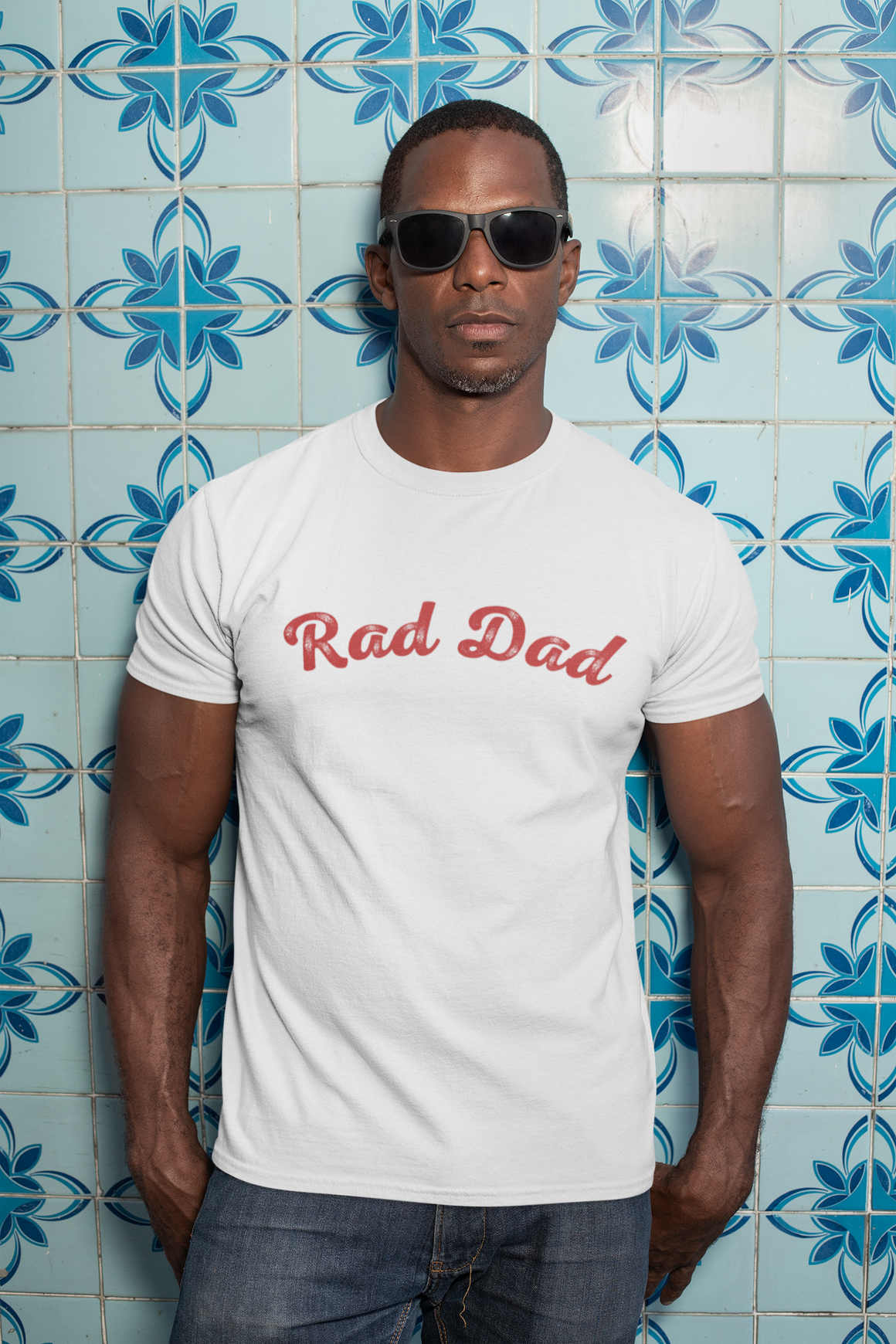 A Man standing ooutside wearing a t shirt with a Red Rad Dad Graphic on the front